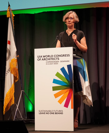 Person speaking at a podium at an architecture congress in Copenhagen.