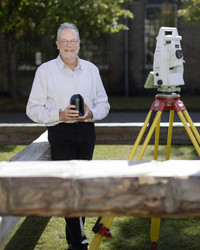 Laser scanner and total station - surrounded by an axe-hewn copy of one of the rafters from "Børsen"
