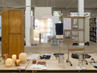 Library exhibition with hanging material samples, mannequin, and display boards