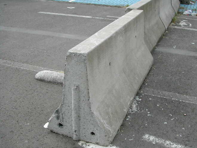 A modular concrete barrier of the type called "New Jersey".
