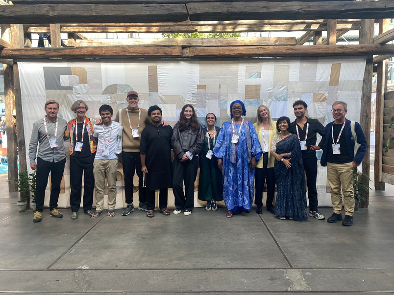 The team in front of the Rebuilding Pavilion