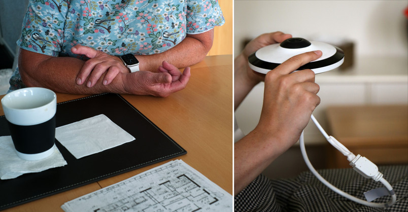 Person ved et bord med kaffekop og smartwatch samt hånd, der holder en sensor.