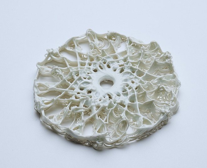 White 3D-printed circular lattice structure with a central hole.