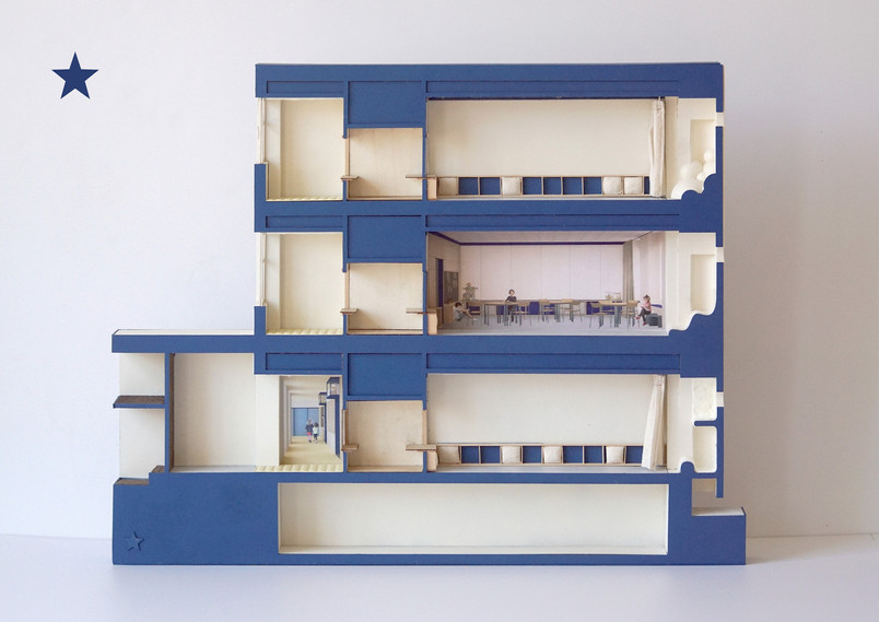 Model showing several stories of classrooms inside the school