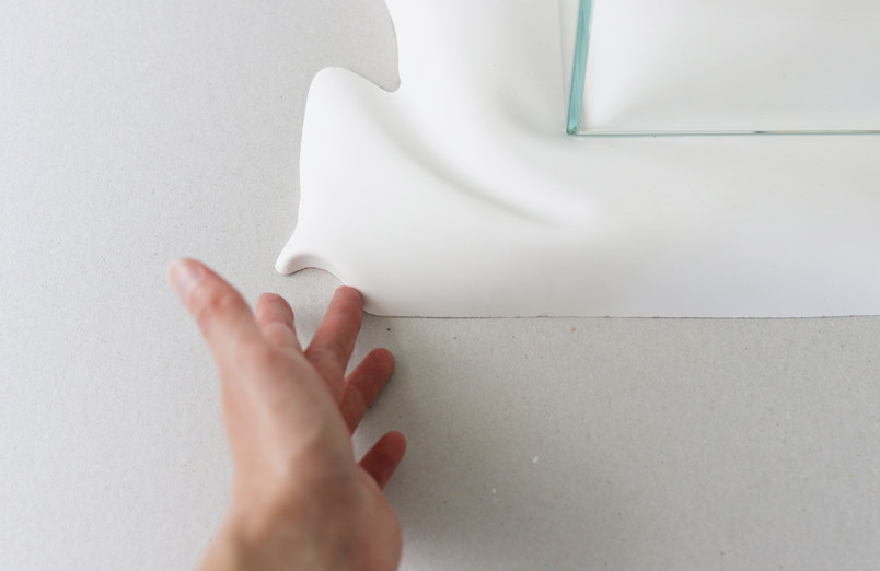 Hand touching folded plaster surface
