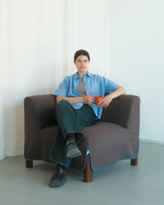 Woman sitting on a brown sofa module