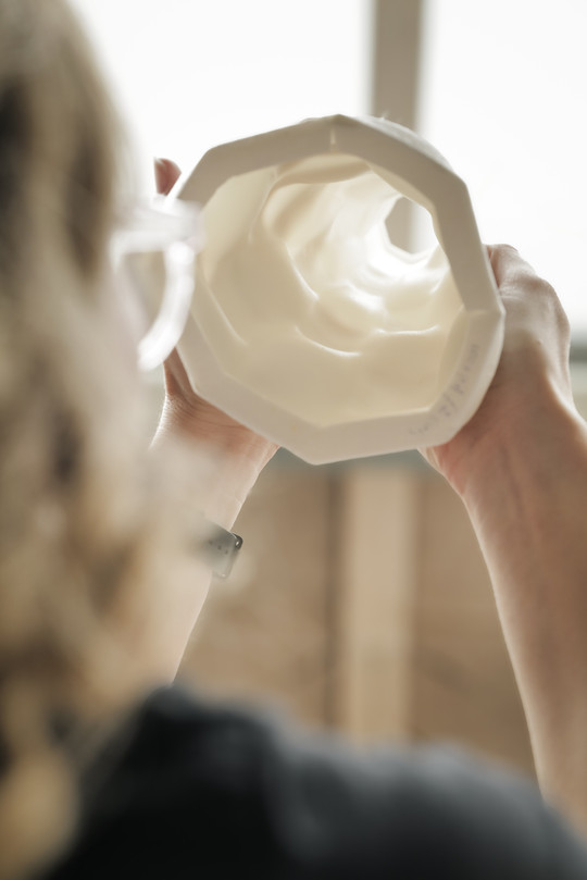 person looking through translucent porcelain object
