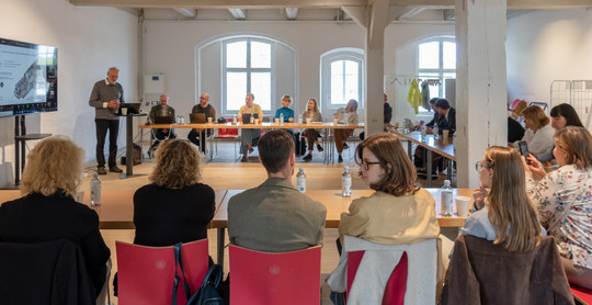 Group of people seated and listening to presentation 