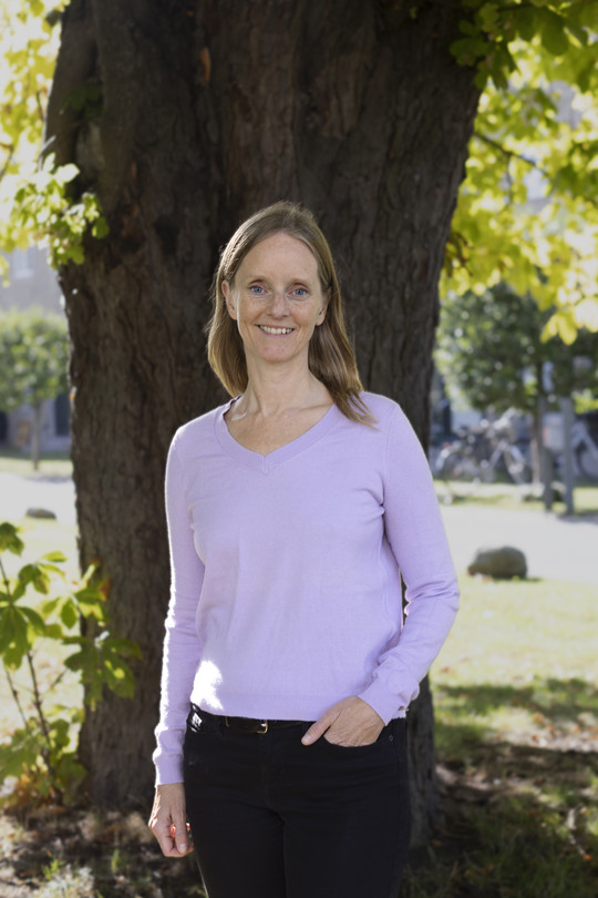 Image of woman in front of chestnut tree
