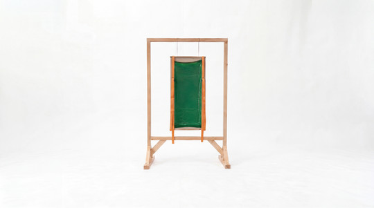 Green translucent panel suspended within a freestanding wooden frame.