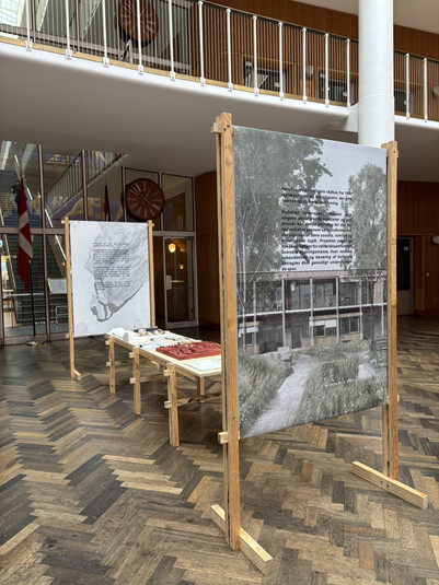 Udstilling med arkitekturmodeller og plancher i en rådhushal.