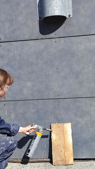 Durability testing the cladding at the workshop with fire .