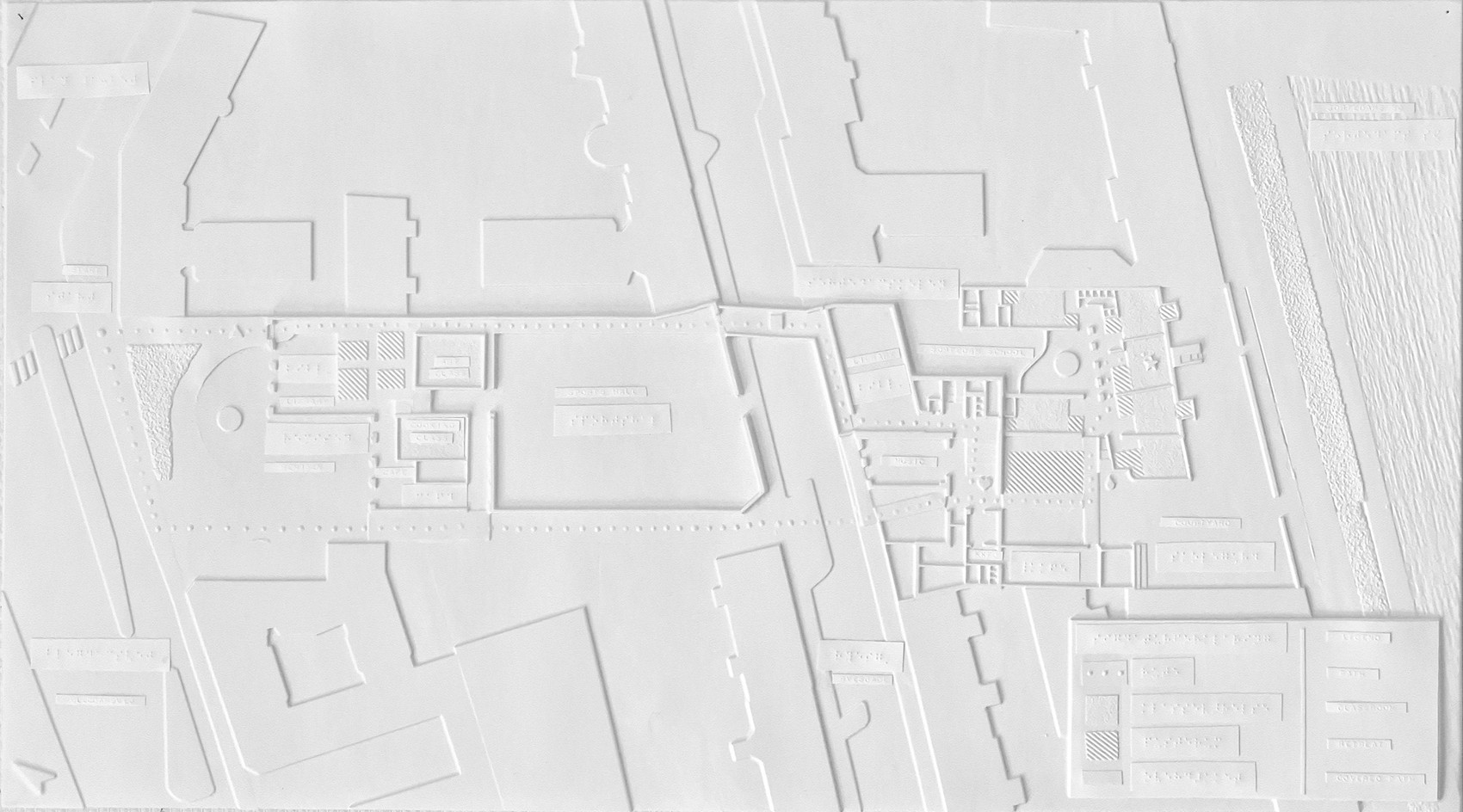 Tactile plan drawing of two buildings and their urban context. 