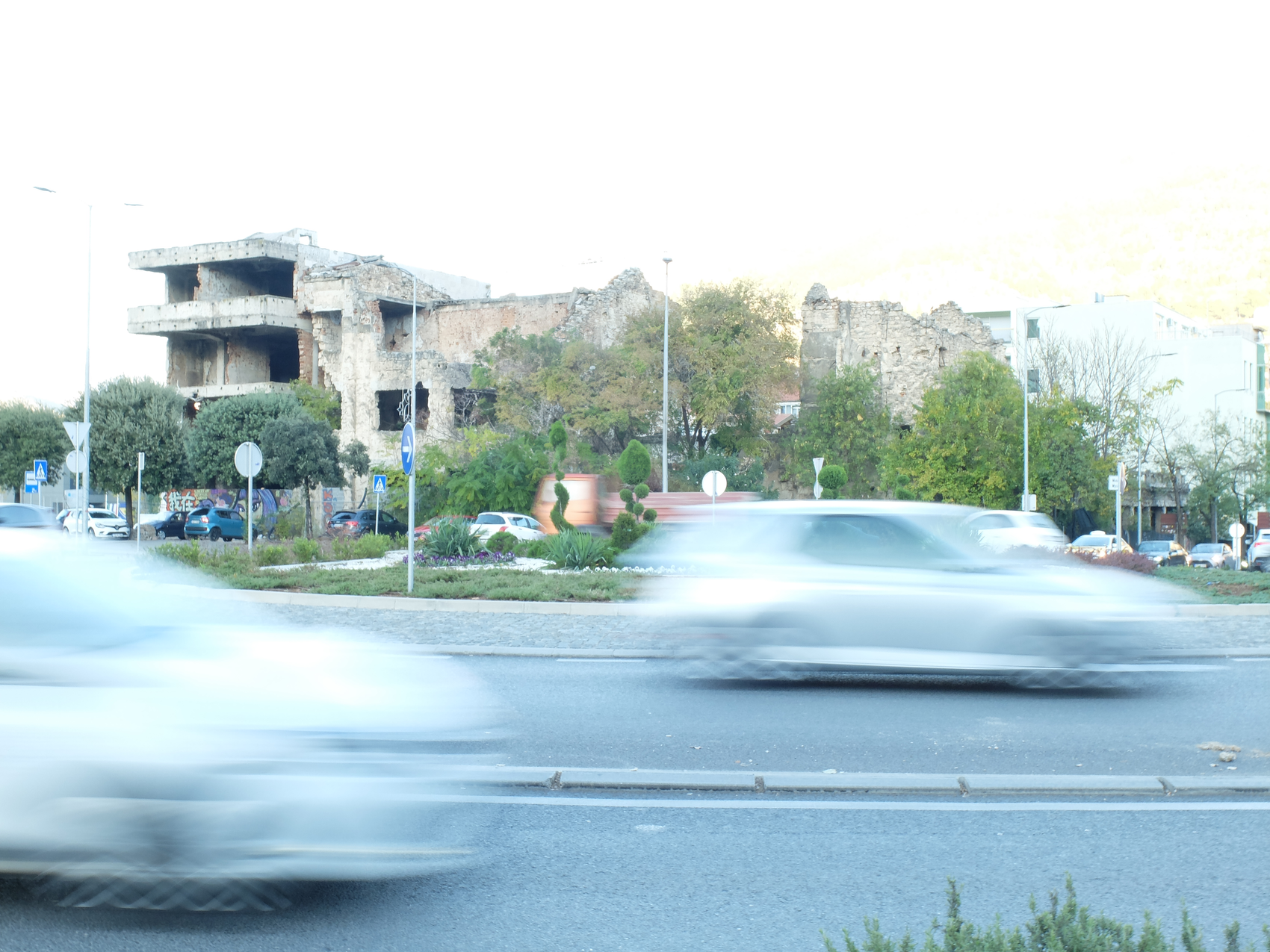 Roundabout with ruin and cars